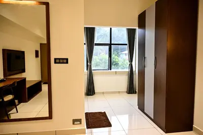 a room with a mirror and a window at Hotel S S International Coorg in Suntikoppa