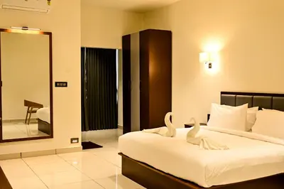 a bedroom with a bed with swans on it at Hotel S S International Coorg in Suntikoppa