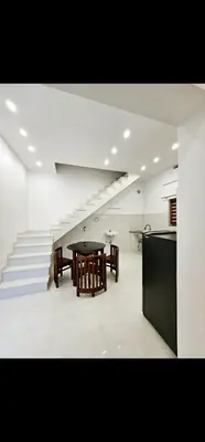 a dining room with a table and some stairs at Mariya Stay in Kanjikode
