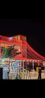 a building decorated with red lights at night at Mariya Stay in Kanjikode