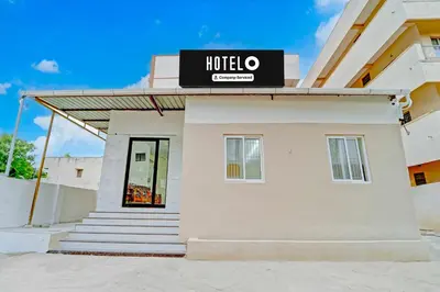 a building with a hotel sign on top of it at Hotel O Coimbatore Peelamedu Railway Station in Coimbatore