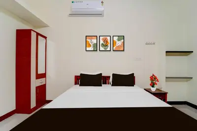 a bedroom with a large white bed in a room at Hotel O Coimbatore Peelamedu Railway Station in Coimbatore