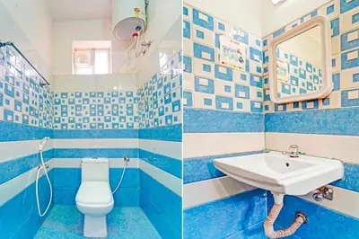 a blue and white bathroom with a sink and a toilet at Collection O Ooty Government Rose Garden in Ooty