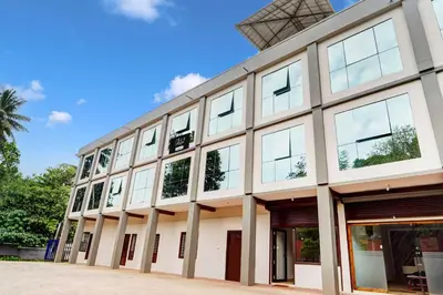 an exterior view of a building with many windows at Collection O Waynad Near Sulthan Bathery in Wayanad