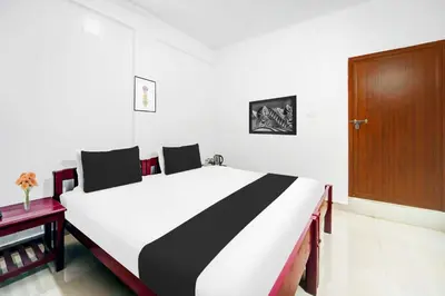 a black and white bed in a room at Collection O Waynad Near Sulthan Bathery in Wayanad