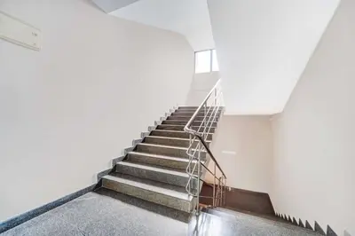 a staircase in a building with a metal railing at Collection O Waynad Near Sulthan Bathery in Wayanad