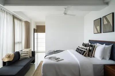 a hotel room with a bed and a couch at Quad One in Kozhikode
