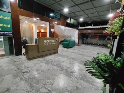 a lobby with a sign in the middle of a building at Nandan Suits in Mysore