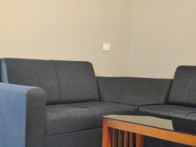 a living room with a couch and a table at Dreams Arcade in Nedumbassery