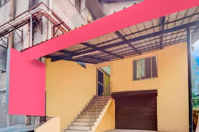 a building with a red ribbon on the side of it at Collection O Kunnamangalam Near Bus Stand in Kunnamangalam