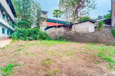 an empty yard next to a brick wall at Collection O Kunnamangalam Near Bus Stand in Kunnamangalam