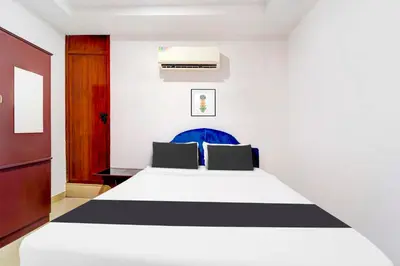 a bedroom with a bed with black and white stripes at Collection O Kunnamangalam Near Bus Stand in Kunnamangalam