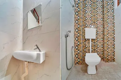 a bathroom with a sink and a toilet at Collection O Erode VOC Park in Erode