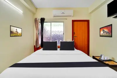 a bedroom with a bed and a television in it at Collection O Erode VOC Park in Erode