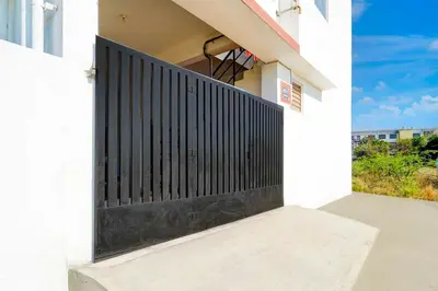 a black gate on the side of a house at Collection O Neelambur Near PSG ITech in Irugūr