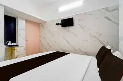 a bedroom with a bed and a tv on the wall at Collection O IIT College Coimbatore in Coimbatore