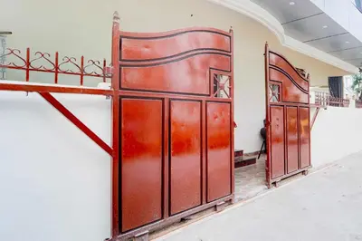 a pair of red metal doors in a room at Collection O IIT College Coimbatore in Coimbatore