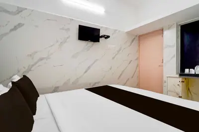 a room with a tv on a marble wall at Collection O IIT College Coimbatore in Coimbatore