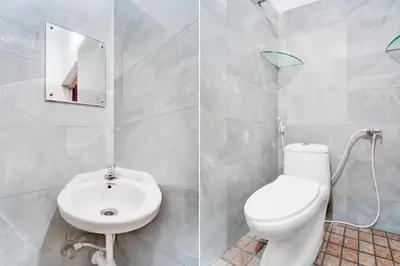 a bathroom with a white toilet and a sink at Collection O IIT College Coimbatore in Coimbatore