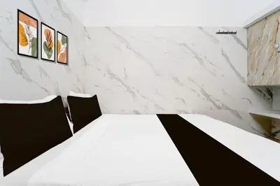 a room with a white table and two chairs at Collection O IIT College Coimbatore in Coimbatore