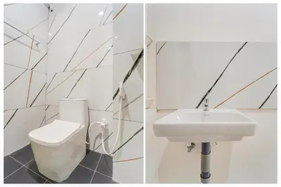 a white bathroom with a toilet and a sink at Super Collection O RS Puram North Railway Station Formerly RG Residency in Coimbatore