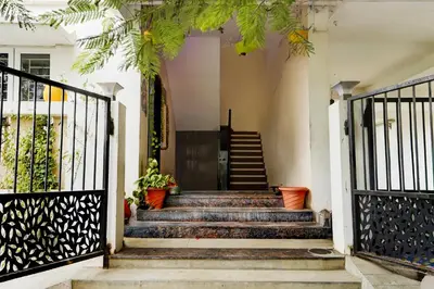 a set of stairs leading up to a house at Hotel O Ondipudur Bus Terminal Formerly New Paradise Inn in Irugūr