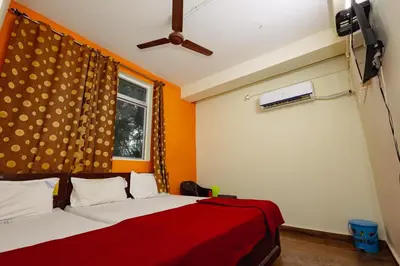 a bedroom with a bed with a red blanket and a window at Pvt Residency in Palani