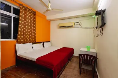 a small room with a bed and a chair at Pvt Residency in Palani