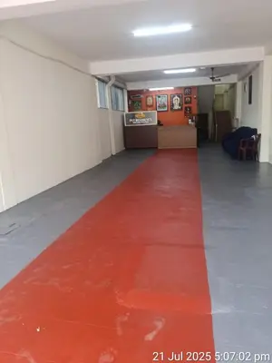 an empty room with a red carpet on the floor at Pvt Residency in Palani