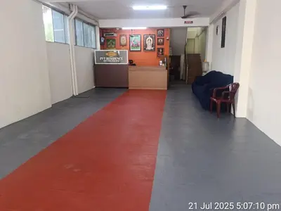 a hallway with a red carpet in a room at Pvt Residency in Palani