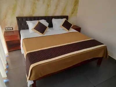 a bedroom with a large bed with two pillows at Vipinam, The riverside retreat in Kotamangalam