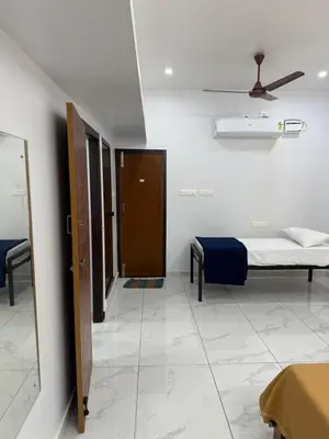 a hospital room with a bed and a mirror at Joseph's Residency Homestay in Podanūr