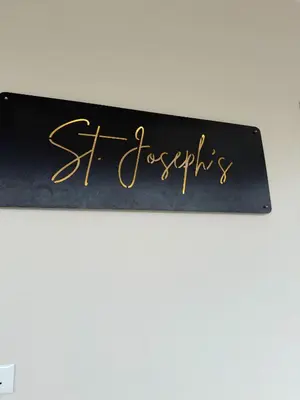 a black sign with gold writing on it at Joseph's Residency Homestay in Podanūr