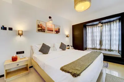 a bedroom with a large white bed and a window at Garden Haven 3 BHK Villa with Balcony and Verandah Escape in Kotagiri