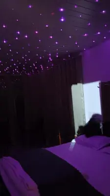 a purple bedroom with purple lights on the ceiling at Rain view wayanad in Wayanad