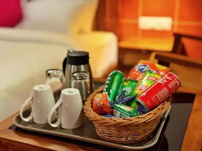 a tray with a basket of snacks on a table at Leopard Hill Resort - Bandipur in Bandipūr