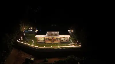 a house with lights on it at night at Banbury Bungalow in Kanthalloor