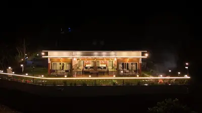 a building with lights in front of it at night at Banbury Bungalow in Kanthalloor