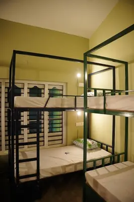 a room with four bunk beds in it at Dormer Stay in Kozhikode