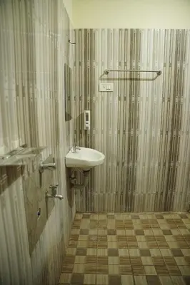 a bathroom with a sink and a shower at Dormer Stay in Kozhikode