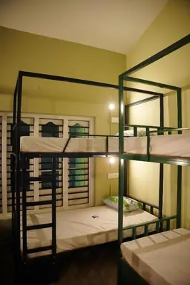 a room with four bunk beds in it at Dormer Stay in Kozhikode