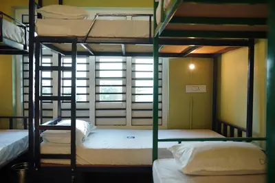two bunk beds in a room with a window at Dormer Stay in Kozhikode