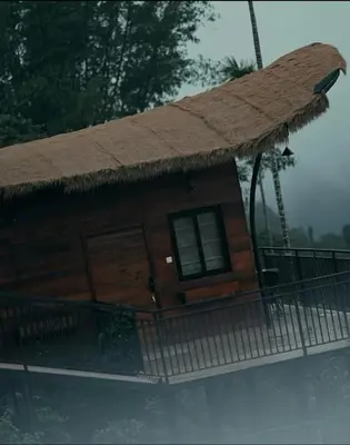 a house with a thatch roof on top of it at Jalsa Bali, Kakkadampoyil, Calicut in Kakkadampoyil