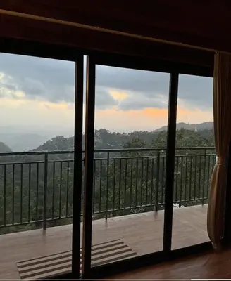 a view from a window of a balcony with a view at Jalsa Bali, Kakkadampoyil, Calicut in Kakkadampoyil