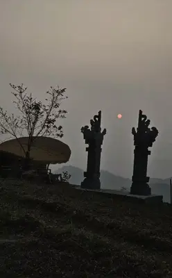 two statues in a park with the moon in the sky at Jalsa Bali, Kakkadampoyil, Calicut in Kakkadampoyil