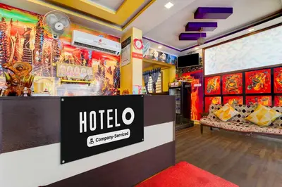 a hotel room with a sign on the wall at Hotel O Gandhipuram Central Bus Stand in Coimbatore