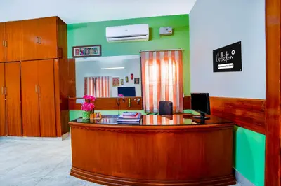 a law office with a reception desk with a sign on the wall at Collection O Singanallur Coimbatore in Coimbatore