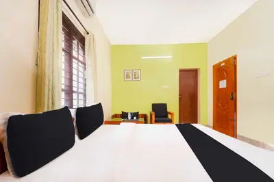 a bedroom with a large bed with black and white at Collection O Singanallur Coimbatore in Coimbatore