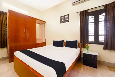 a bedroom with a large bed in a room at Collection O Singanallur Coimbatore in Coimbatore