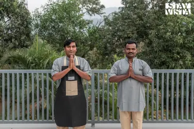 two men standing in front of a fence praying at The Secret Glen by VEO - Part of StayVista with BBQ & Bonfire in Ooty